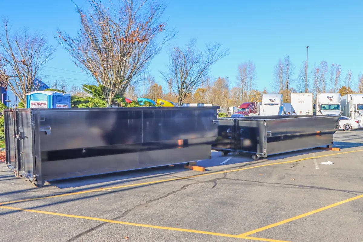 Professional dumpster rental service with roll-off container on residential driveway in Jesup